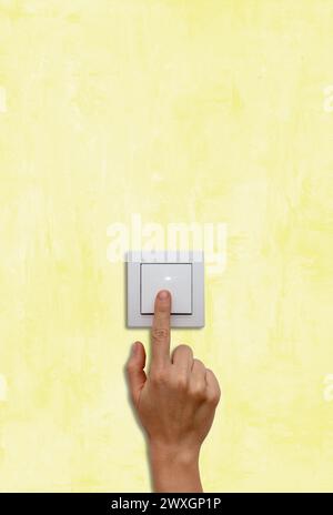 Female finger on light switch close-up. Stock Photo