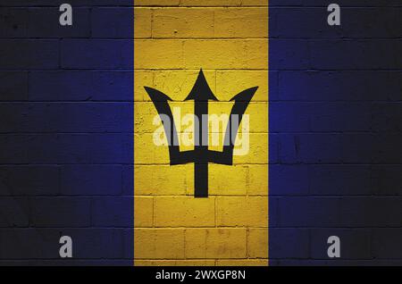 Flag of Barbados painted on a cinder block wall. Stock Photo