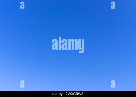 Beautiful blue sky without clouds in the morning or evening is used as natural background texture in decorative art work. Stock Photo