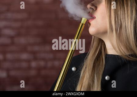 Beautiful young woman smokes a hookah in a cafe, Egypt Stock Photo - Alamy