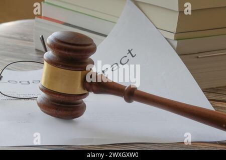 Judicial mallet on a legal document with books and reading glasses Stock Photo