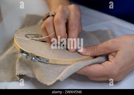 Hands of women embroidering by hand Stock Photo