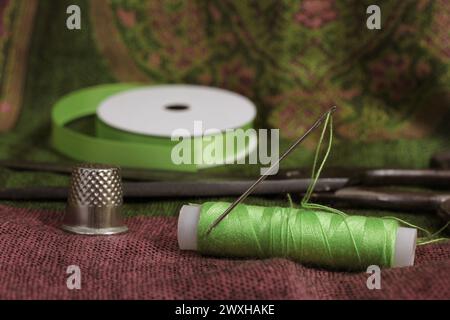 Assorted spools and sewing tools on table Stock Photo