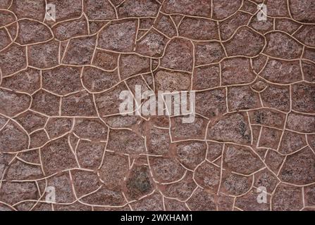 Stone wall texture with rough and chipped cracks, reminiscent of old Indian architecture Stock Photo