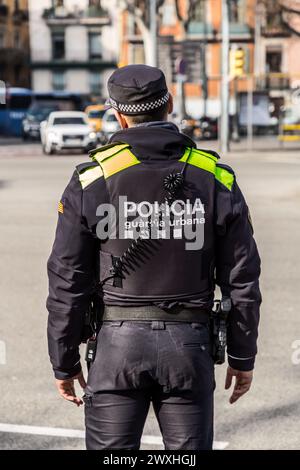 Barcelona, Spain - FEB 10, 2022: Urban guard policeman in his uniform, on duty in the streets of Barcelona, Spain. Stock Photo