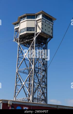 Barcelona, Spain - FEB 10, 2022: Torre Sant Sebastia is a 78 metre tall free standing lattice tower in Barcelona, Catalonia, Spain which is used as a Stock Photo