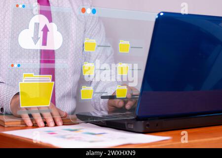 Entrepreneur using a laptop documenting management concept, online database and digital file storage in the cloud, record keeping, easy access to file Stock Photo