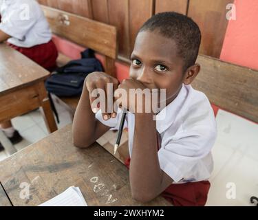 INDONESIA, ISLAND KRI - JANUARY 29, 2024: Papuan boy in school uniform looking at the camera Stock Photo