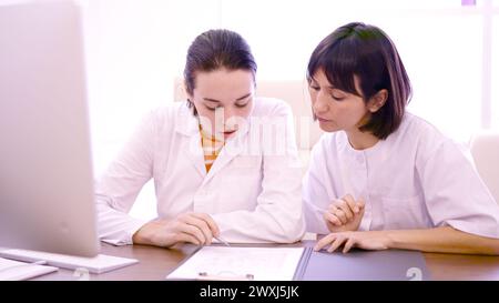 Two female doctor consulting a medical report Stock Photo
