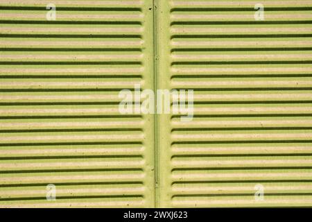 Colorful weathered corrugated sheet metal closeup as grunge metal background Stock Photo