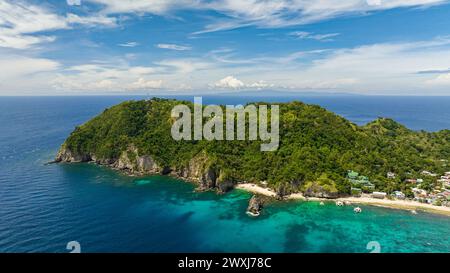Top view of Apo Island with a beautiful beach and marine reserve. Popular dive site and snorkeling destination with tourists. Negros, Philippines. Stock Photo
