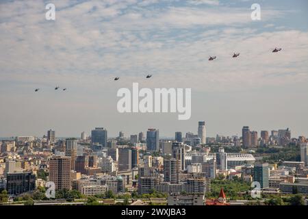 Kyiv, Ukraine - August 22., 2021: Aerial summer cityscape with flying different military helicopters during parade dedicated to Independence Day of Uk Stock Photo