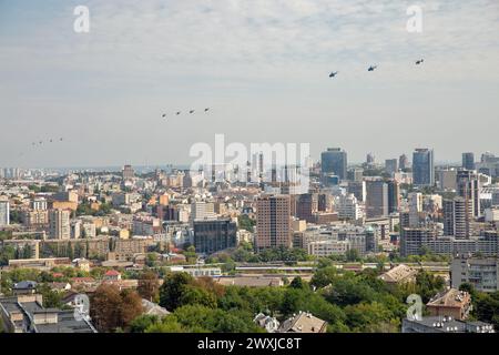 Kyiv, Ukraine - August 22., 2021: Aerial summer cityscape with flying military helicopters during parade dedicated to Independence Day of Ukraine. Stock Photo
