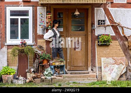 Old half-timbered house, entrance curiously decorated with mannequin in costume, carpenters' guild, traditional clothing, Nidda, Vogelsberg Stock Photo