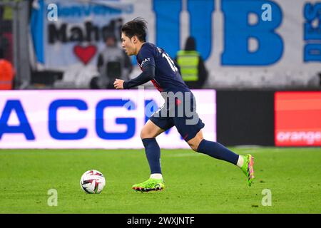 Marseille, France. 31st Mar, 2024. MARSEILLE, FRANCE - MARCH 31: Kang-in Lee of Paris Saint-Germain runs with the ball during the Ligue 1 Uber Eats match between Olympique de Marseille and Paris Saint-Germain at Orange Velodrome on March 31, 2024 in Marseille, France. (Photo by Matthieu Mirville/BSR Agency) Credit: BSR Agency/Alamy Live News Stock Photo