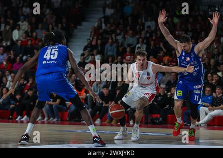 Varese, Italy. 30th Mar, 2024. Hugo Besson #25 of Pallacanestro Varese OpenJobMetis (C) and John Petrucelli #11 (R) and Nicola Akele #45 of Germani Brescia (L) seen in action during LBA Lega Basket A 2023/24 Regular Season game between Pallacanestro Varese OpenJobMetis and Germani Brescia at Itelyum Arena. Final score; OJM Varese 92 : 95 Germani Brescia. (Photo by Fabrizio Carabelli/SOPA Images/Sipa USA) Credit: Sipa USA/Alamy Live News Stock Photo