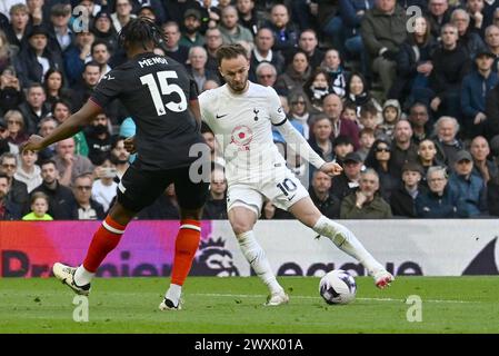 London, UK. 30th Mar, 2024. James Maddison of Tottenham Hotspur (r) battles for the ball with Teden Mengi of Luton Town. Premier League match, Tottenham Hotspur v Luton Town at the Tottenham Hotspur Stadium in London on Saturday 30th March 2024. this image may only be used for Editorial purposes. Editorial use only pic by Sandra Mailer/Andrew Orchard sports photography/Alamy Live news Credit: Andrew Orchard sports photography/Alamy Live News Stock Photo