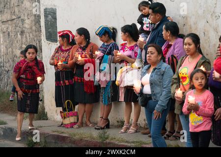 Chichicastenango, Guatemala. 30th Mar, 2024. Indigenous Mayan women wearing traditional huipiles hold a candlelight procession mixing Christian and Mayan beliefs on Holy Saturday from the Cementerio De Chichicastenango, March 30, 2024 in Chichicastenango, Guatemala. The Catholic Church and Mayan beliefs long ago mixed together in indigenous regions of Guatemala in a process called syncretism. Credit: Richard Ellis/Richard Ellis/Alamy Live News Stock Photo