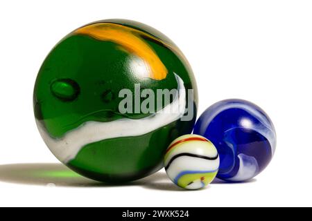 Three glass marbles in three different sizes. Stock Photo