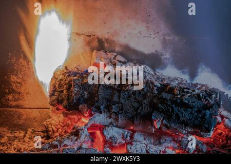 Close-up of birch logs burning in the fireplace of a villa. Sweden. Stock Photo