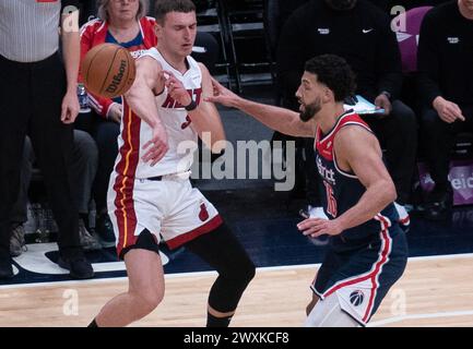 Washington, USA. 31st Mar, 2024. WASHINGTON, DC - MARCH 31: Miami Heat forward Nikola Jovic (5) sends a pass away from Washington Wizards forward Anthony Gill (16) during a NBA game between the Washington Wizards and the Miami Heat, on March 31, 2024, at Capital One Arena, in Washington, DC. (Photo by Tony Quinn/SipaUSA) Credit: Sipa USA/Alamy Live News Stock Photo
