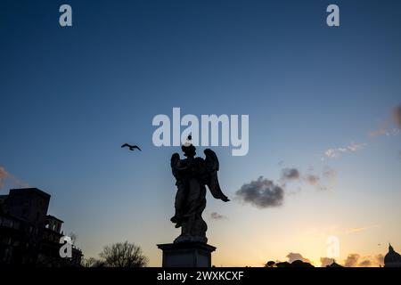 Angel statue on St. Angelo Bridge in Rome, Italy, at night Stock Photo