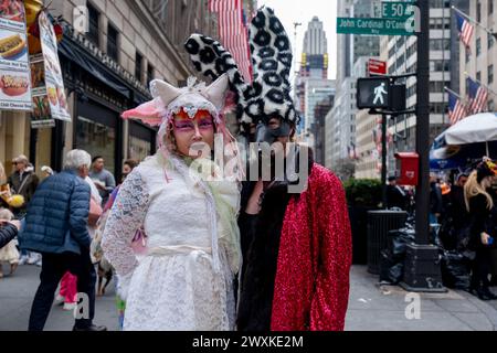 New York City, United States. 31st Mar, 2024. A couple dressed for the parade. New York's Easter Parade and Bonnet Festival dates back to the 1870s. An Anual event, New Yorkers don colorful and creative Easter outfits to show off in front of St Patrick's Cathedral on Fifth Avenue. Credit: SOPA Images Limited/Alamy Live News Stock Photo