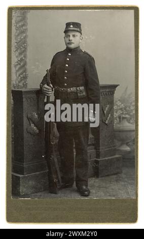 Early 1900's Carte de Visite (visiting card or CDV) of armed Swedish soldier, in uniform holding a rifle, from the photographic studio of Albin Berns, Backamo, Vastra Gotaland region of Sweden, circa 1900. Stock Photo