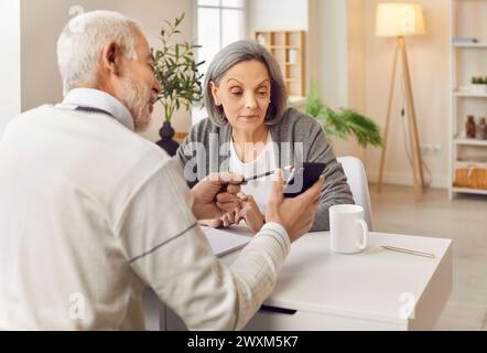 Senior couple smartphone application using, older adults learn how to interact with phone  Stock Photo