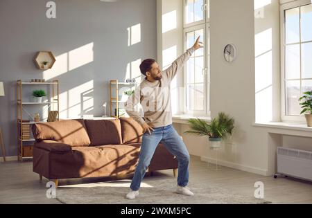 Young readhead man wearing casual clothes dancing in the living room at home Stock Photo