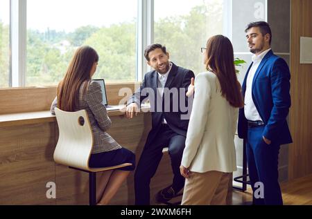 Business people diverse team talking together, young happy male, female businesspersons Stock Photo