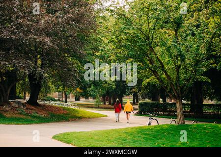 Two college students walking on campus wearing bold colors Stock Photo