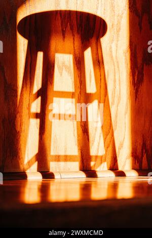 Shadow of kitchen stool on kitchen cabinets Stock Photo
