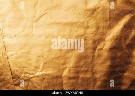 Texture of gold colored wrapping paper surface as background Stock Photo