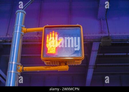 A sideways traffic light displaying a hand signal Stock Photo