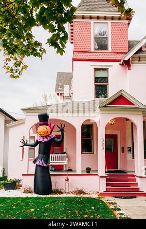 Halloween inflatable in front yard of pink historic mansion Stock Photo