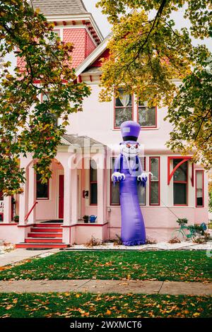 Large Halloween inflatable in front yard of pink mansion house Stock Photo