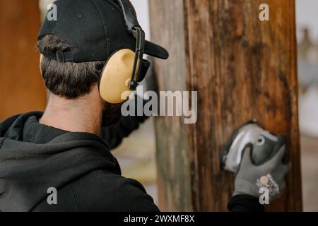 A man cutting a tree with a circular saw Stock Photo