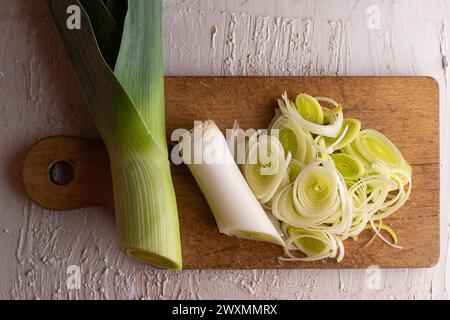 Sliced leek on a wooden board. Rustic surroundings. Kitchen with vegetables. Green in the kitchen Stock Photo