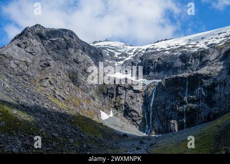 Snowmelt waterfalls running off Mount Talbot, Fiordland National Park, Southland, South Island, New Zealand Stock Photo