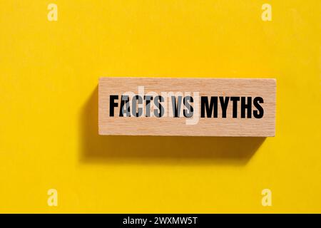 Facts vs myths words written on wooden block with yellow background. Conceptual symbol. Copy space. Stock Photo