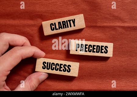 Clarity precedes success words written on wooden blocks with brown background. Conceptual business symbol. Copy space. Stock Photo