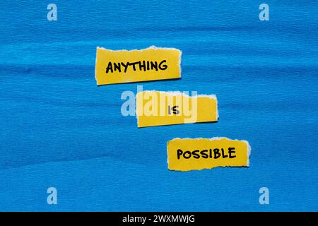 Anything is possible words written on yellow torn paper pieces with blue background. Conceptual symbol. Copy space. Stock Photo