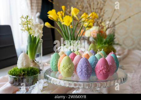 Colorful easter egg soy wax candles. Spring background Stock Photo