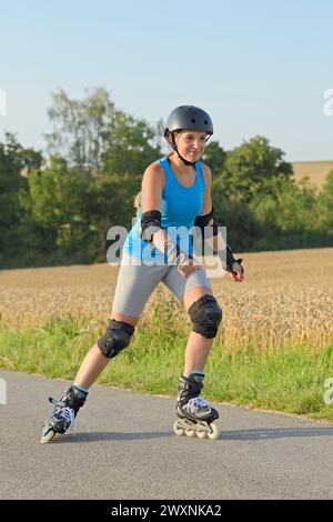 Young woman inline skating Stock Photo