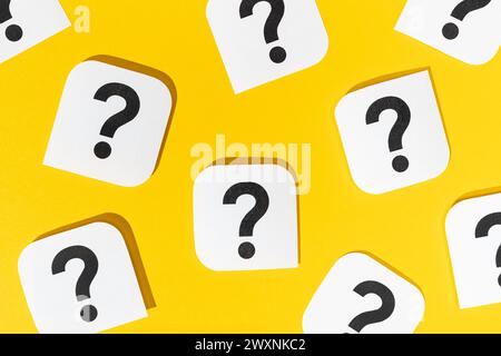 Many Question marks signs on yellow background Stock Photo