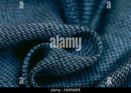 A close-up of blue knitted fabric with a loop knot, highlighting thread details Stock Photo