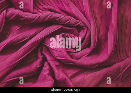 A purple wavy fabric with small folds, resembling a curtain Stock Photo