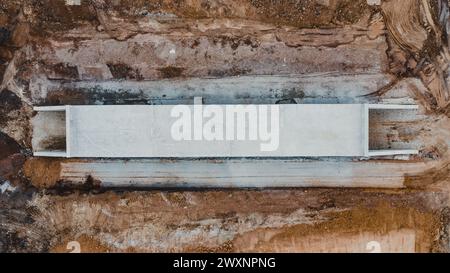 A wooden stand holding a water trough on dirt Stock Photo