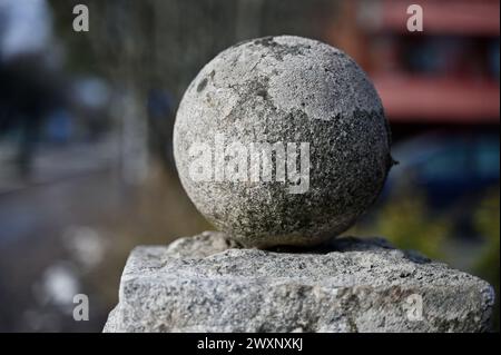 old granite ball covered with moss, architectural detail Stock Photo